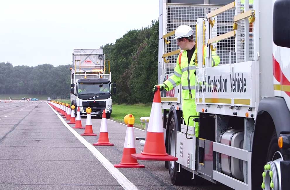 Colas Ltd AutoIPV vehicles and an Operative Laying cones on the road