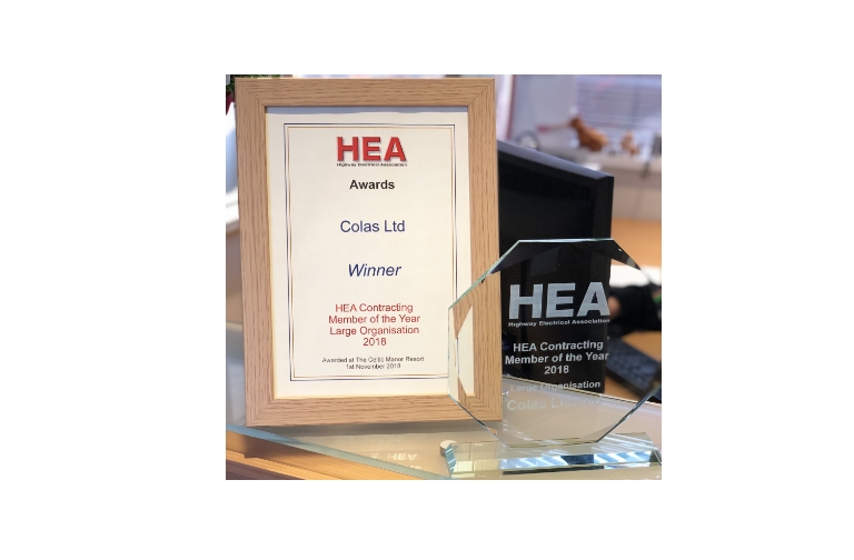 Highway Electrical Association logo award certificate in wooden frame and a glass award